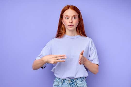 British sign language. A two-handed alphabet. Fingerspelling alphabet. ginger woman demonstrating number 300