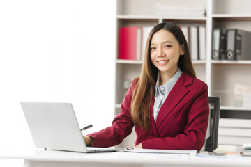 Asian people independent investment consultant captured in her element at office, donning vibrant...