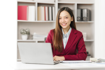 Asian people independent investment consultant captured in her element at office, donning vibrant...