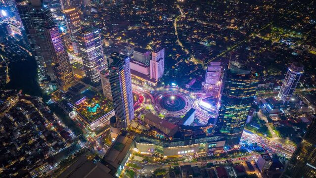 Hyper lapse, Aerial drone view on Selamat Datang Monument roundabout with fast car traffic in Jakarta, Indonesia