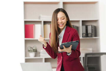 Asian people independent investment consultant captured in her element at office, donning vibrant...