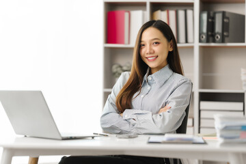 Asian people independent investment consultant captured in her element at office, donning formal business shirt. Her poised demeanor epitomizes blend of tradition modernity in today finance world
