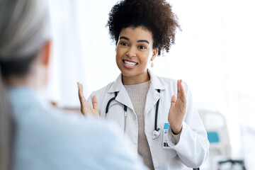 Hospital, consulting and doctor with patient for discussion, talking and empathy for diagnosis...