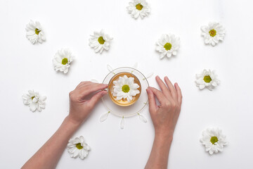 Cup of hot chamomile tea isolated on white background.