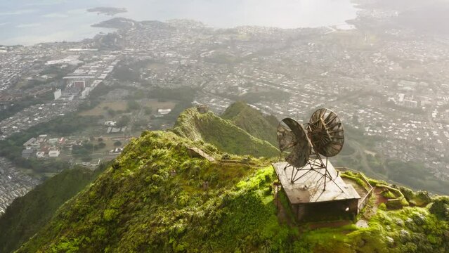 Close up of abandoned old radio naval satellite, industrial military construction from WWII. Epic Stairway to Heaven hike on Oahu, Hawaii island. Dramatic Haiku Stairs on green mountain steep ridge 4K