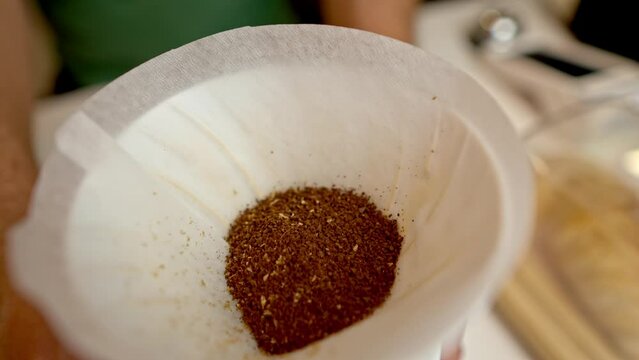 coffee pouder on a white coffee filter and ready to pour water to tart making american filterd coffee