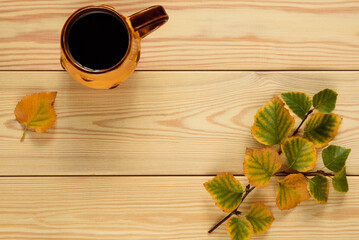 Autumn composition. A cup of coffee and autumn leaves