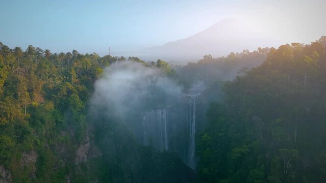 Tumpak Sewu waterfall and Semeru mountain at sunrise located in east java, Lumajang, Indonesia.