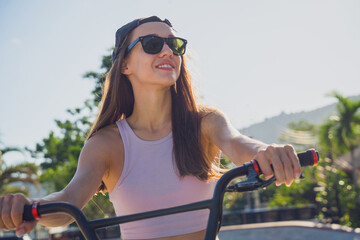 Happy young woman enjoy BMX riding at the skatepark