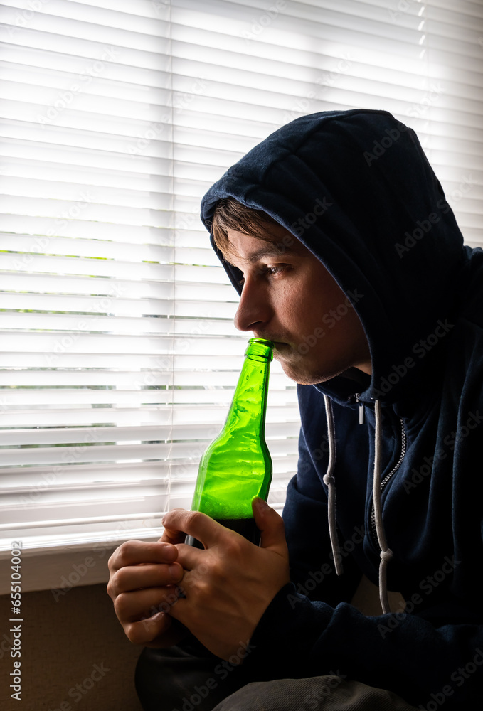 Sticker sad young man with a beer