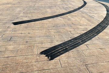 Close-up tire sportcar tread marks on the road.