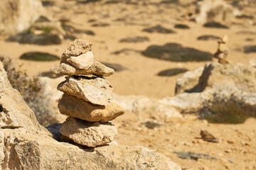 Stones stacked on top of each other with a blurred background.