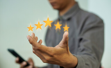 The customer or customer's hand holds all five stars. with copy space Service score The concept of excellent satisfaction, gold star, five star