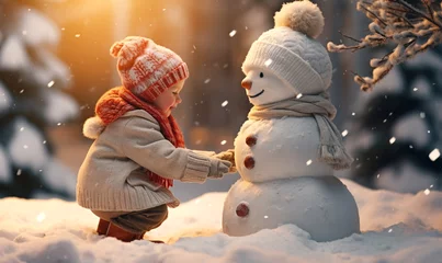 Papier Peint photo Marron profond lachendes Kind im Winter mit Schneemann
