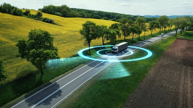 Autonomous, Self-Driving, Driverless Truck of The Future Analyzing Highway. Concept of Smart Freight Transport, Cargo, Shipping Delivery of Goods. Visualization with HUD elements. Aerial view, 4k .