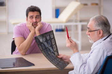 Young male patient visiting old male doctor radiologist