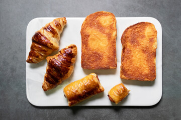 Sizzler bread crispy cheese bread, puff pastry and croissant serving on marble tray.