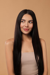 Naklejka premium Beautiful woman with long hair on beige background