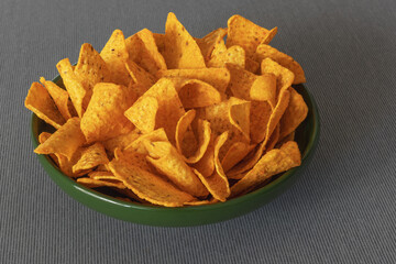 Cheese flavored corn chips in a green bowl