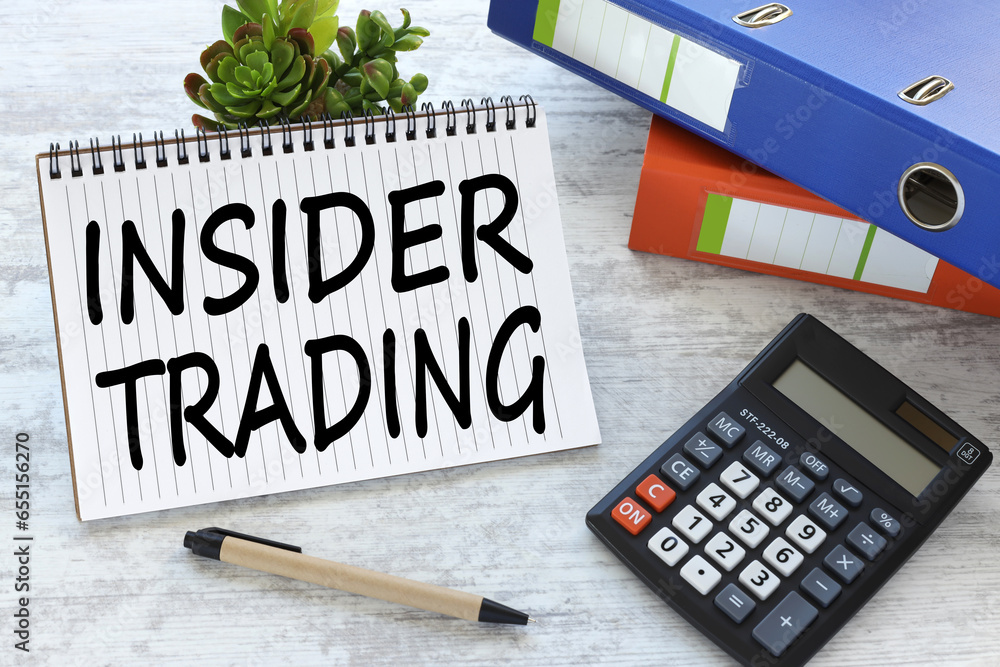 Poster insider trading text written on notebook with keyboard, chart,and calculator.