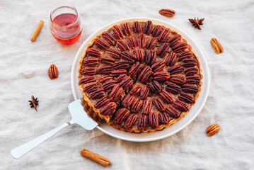 Delicious freshly baked homemade caramel pecan pie that showcases pecan nuts. Classic American...