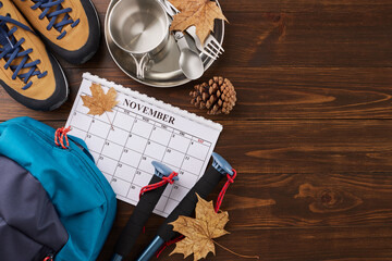 Discovering the magic of autumn on a hike. Top view shot of calendar, metal utensils, trekking...