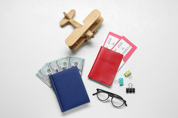 Flat lay composition with tickets, passport and dollars on white table. Business trip