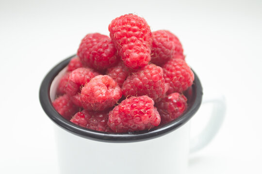 Fresh raspberry berry in a mug
