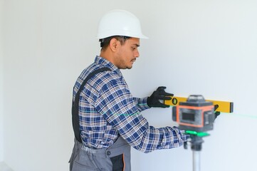 Indian worker makes repairs in an apartment