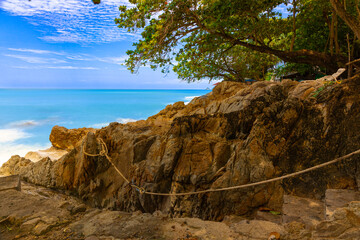 Long exposure of waves crushing against rocks on Patong Beach in Phuket Thailand 