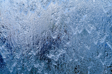 Water jets on a glass waterfall flow down creating a beautiful background.