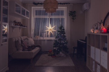 The Christmas tree stood tall in the window of the room, its twinkling lights casting a warm glow...