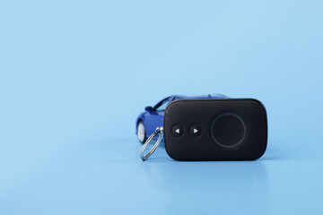 theft protection, car alarm remote control with a car on a blue background, copy space