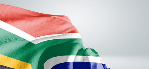 South Africa national flag cloth fabric waving on beautiful sky Background. © Rehan