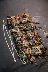 Chocolate Donuts with rich cream with rainbow sprinkler strands