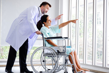 Doctor caring for a patient sitting in a wheelchair.