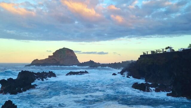 View of the rocks and waves of the ocean at sunset