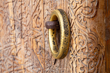 The ring is placed on the handle outside the door