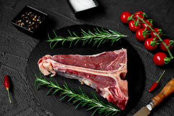 raw T-bone steak on stone background