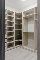 The interior of an empty dressing room is a lot of white shelves