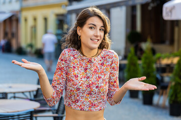 I don't know what to say. Confused young woman feeling embarrassed about ambiguous question, having...