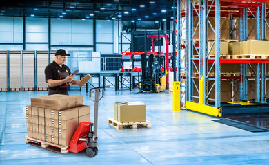 Man is storekeeper. Logistics warehouse employee. Guy near pallet jack with boxes. Contractor for...