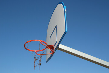 Orange Basketball Hoop with Broken Chain Net and Blue Sky - 655204045