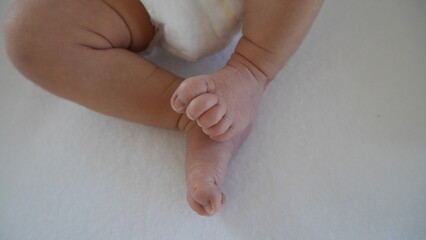 Newborn baby's legs and tiny feet.