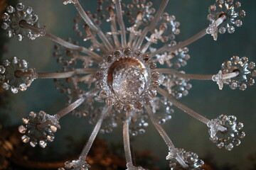 A CHANDELIER HANGING ON THE CEILING, SEEN FROM BELOW