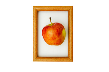 Photo of red - yellow apple in a wooden frame