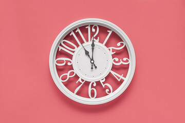 Circle clock on pink background wall