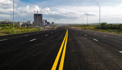 Newly built road. Road under construction. New area in the city. Big avenue. Urbanization. Autumn 2023. Ust-Kamenogorsk (kazkahstan)