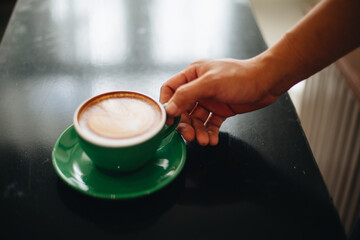 Fototapeta na wymiar Drink hot coffee in a green mug
