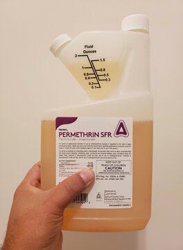 Wilmington, Delaware, U.S - September 27 , 2023 - Holding a 32 ounce of Permethrin SFR bottle, a pesticide to kill pests on plants